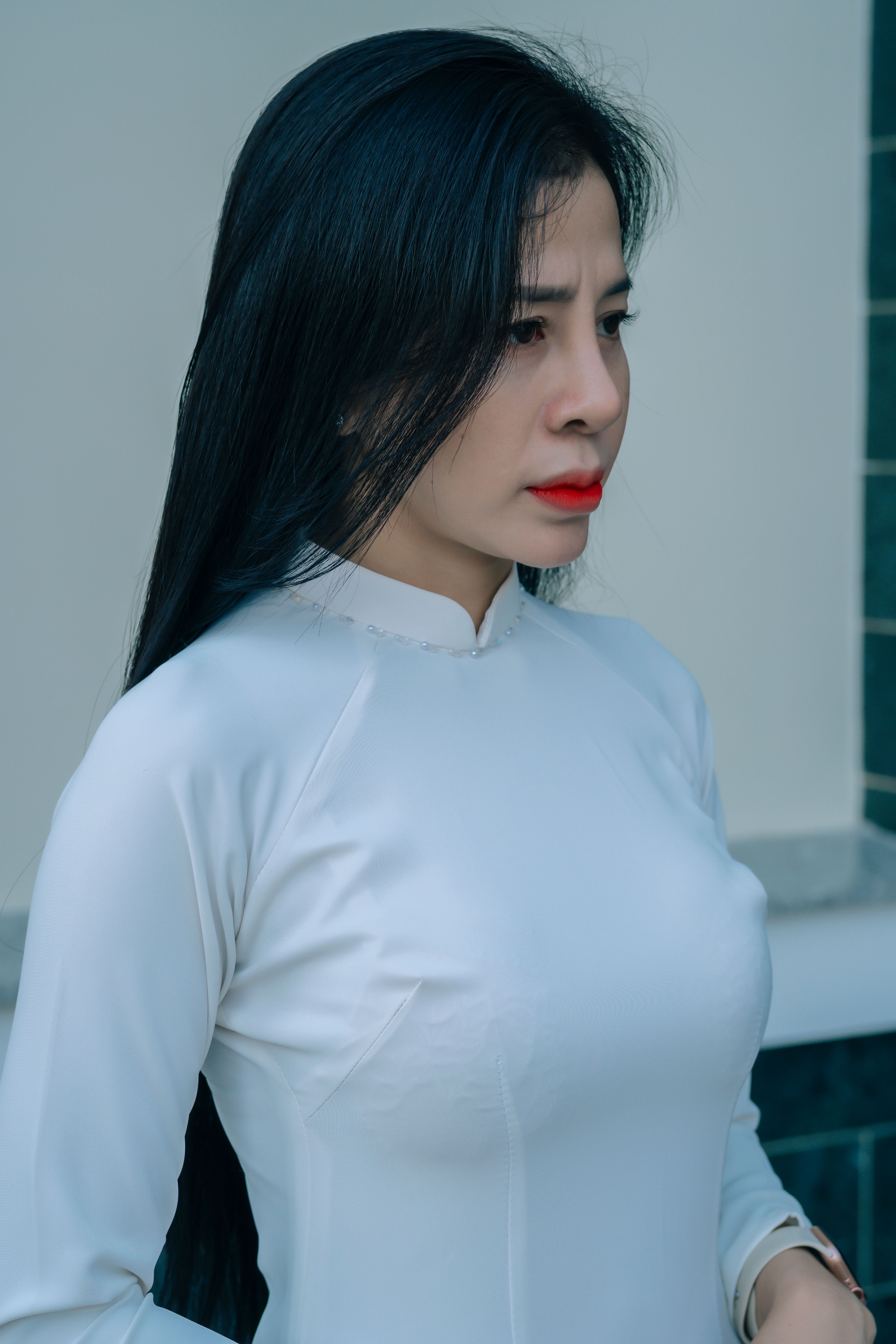 Portrait of a young woman in a traditional white dress, exuding grace and beauty.