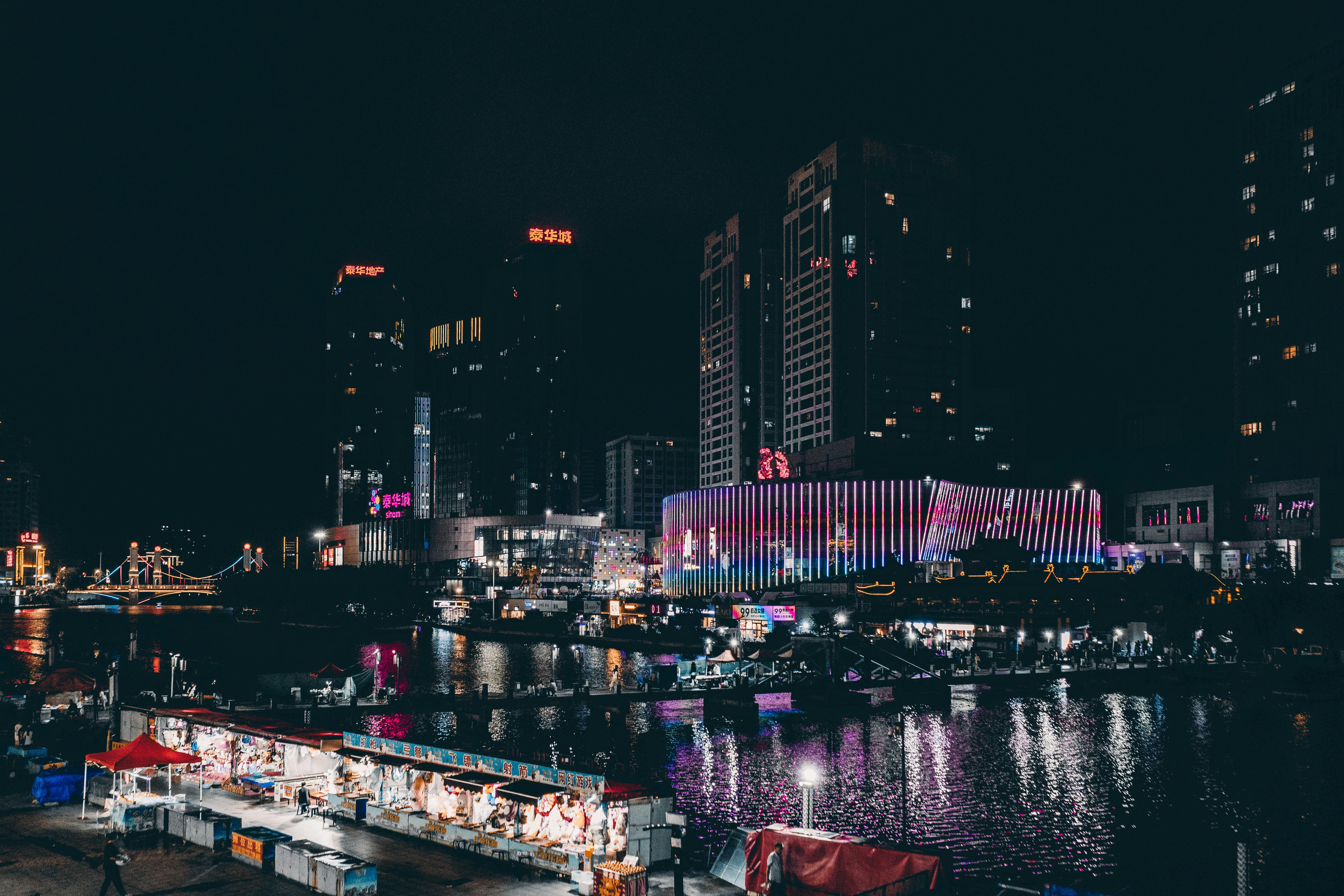 A city at night with boats and buildings
