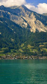 Breathtaking landscape of Lake Brienz and Swiss Alps on a sunny day.