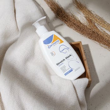 Elegantly presented stretch mark cream bottle with natural materials for skincare routines.