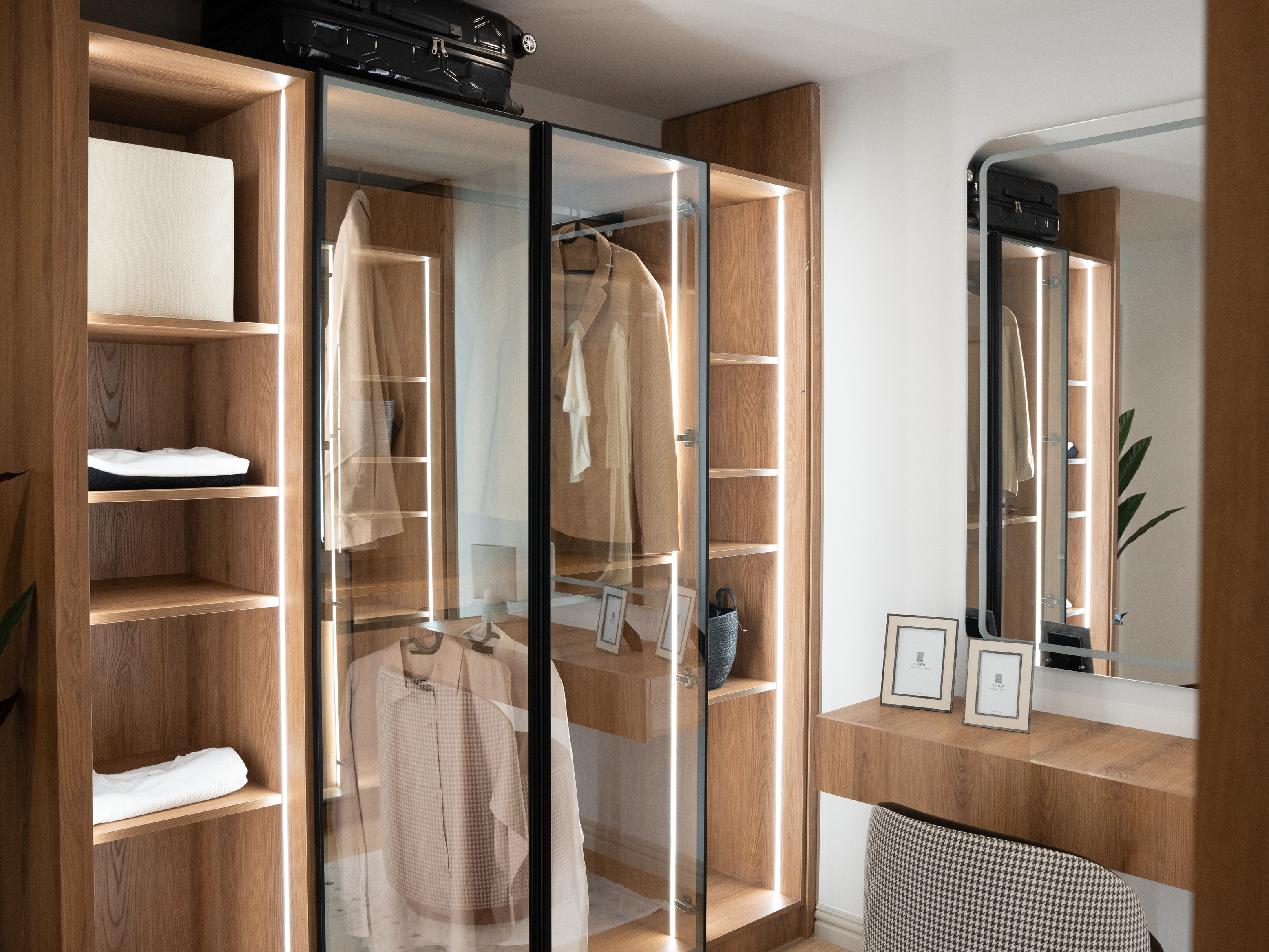 Elegant wardrobe with glass sliding doors and wooden interior shelving