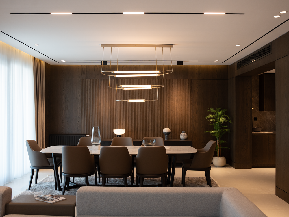 Harmonious dining interior pairing oiled white oak with architectural bronze pendants