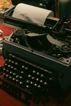 Close-up of a classic typewriter on a wooden desk, evoking nostalgia and vintage charm.