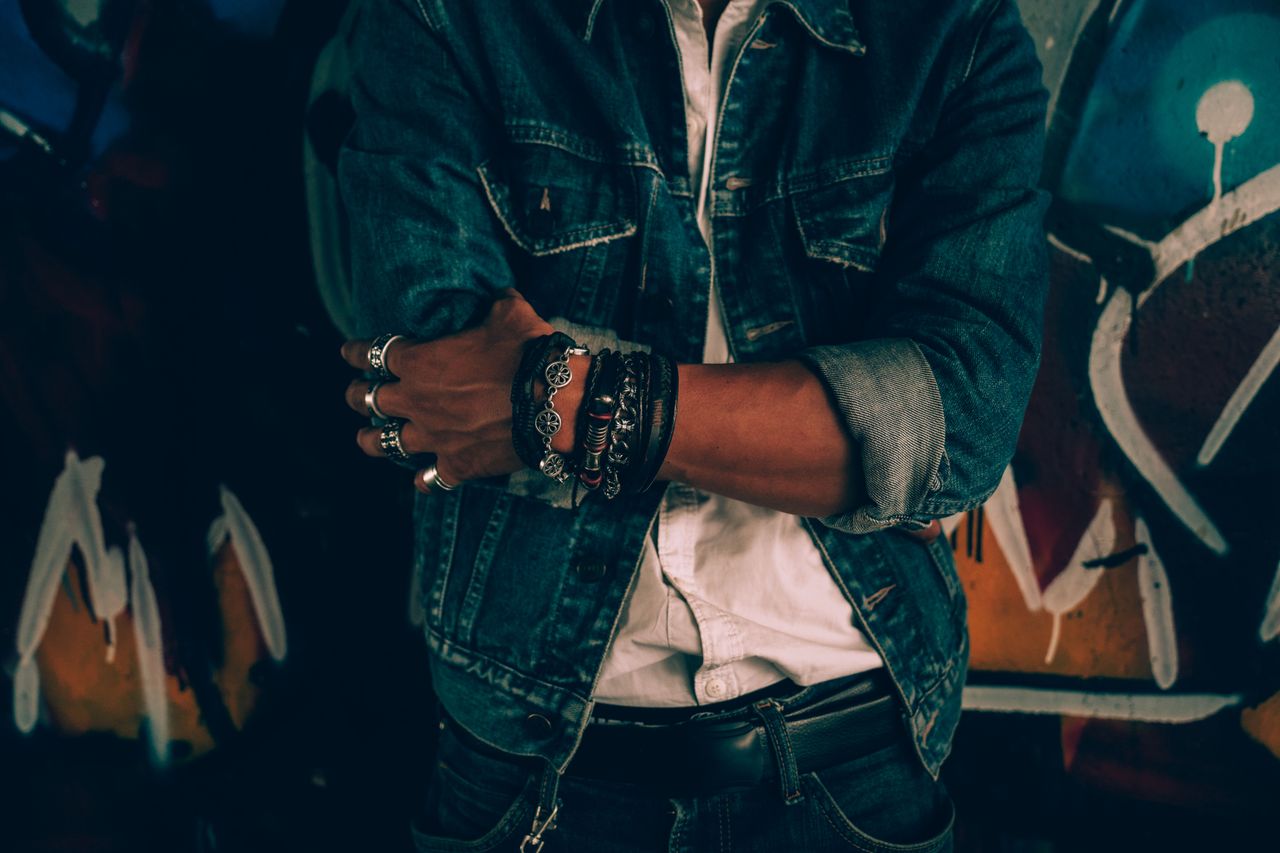 close up portrait of an adult in casual denim fashion against graffiti