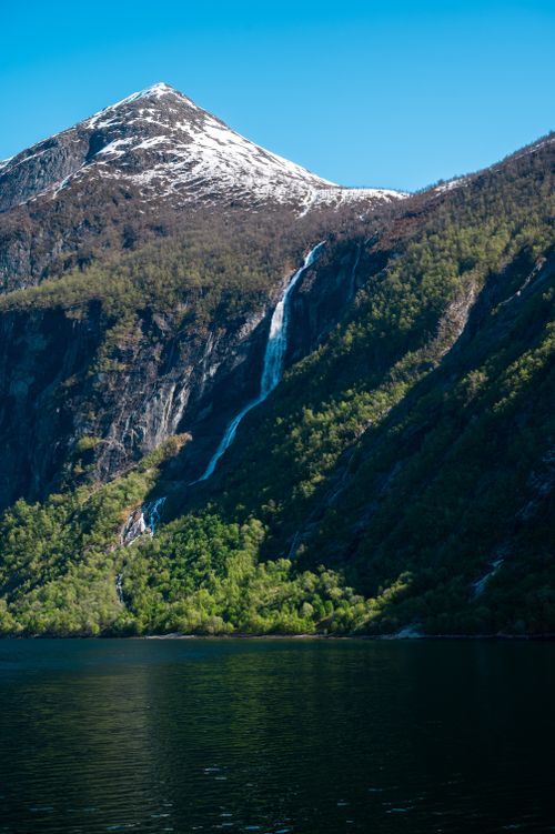 Free Breathtaking view of a waterfall cascading down a mountain in Geiranger, Norway. Stock Photo