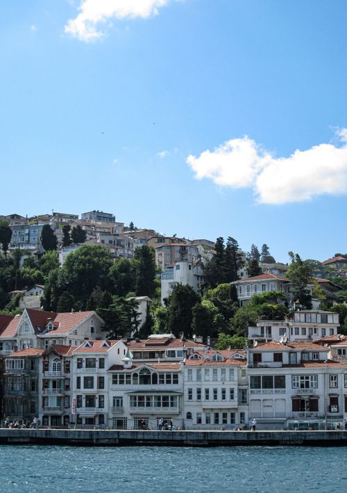 Free Charming coastal town with historic architecture by the sea under clear blue skies. Stock Photo