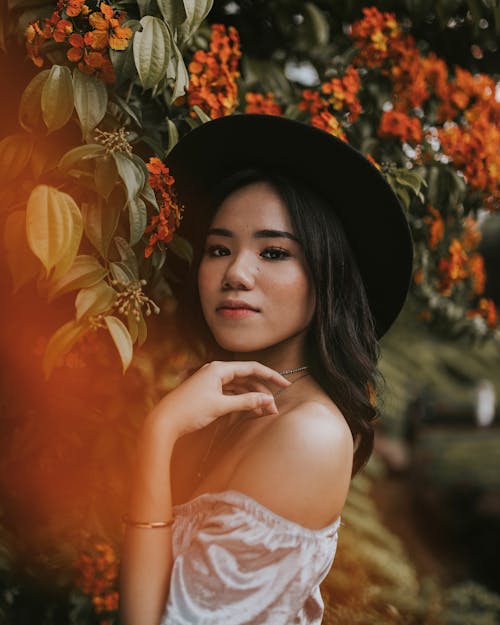 Woman Wearing An Off Shoulder Blouse Taking Selfie Outdoors