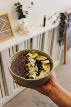 Delicious homemade berry pudding with bananas and almonds in an indoor setting.