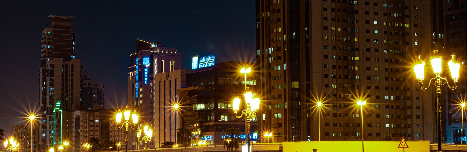 Stunning night view of Sharjah cityscape with modern skyscrapers and lit streets.
