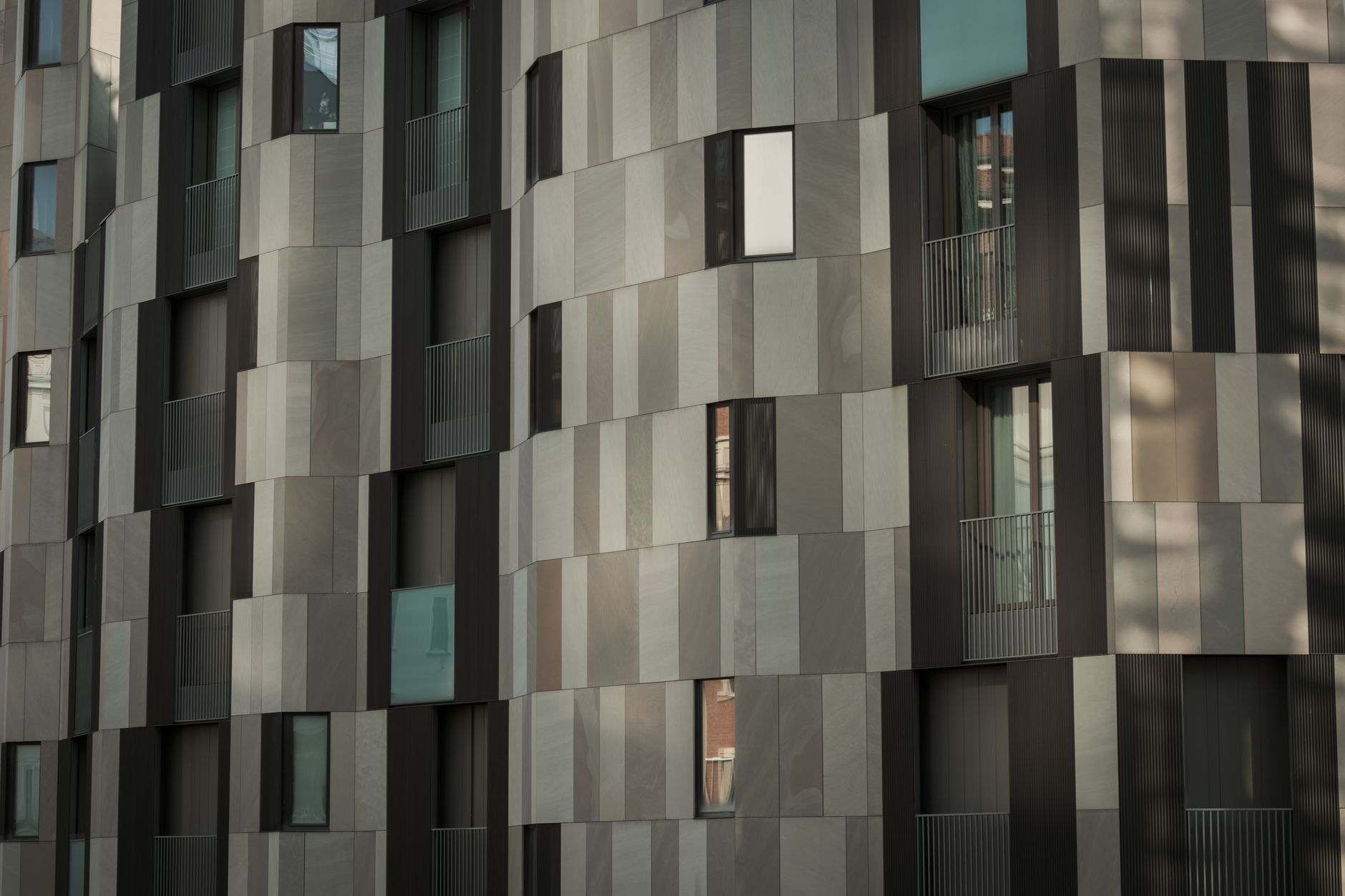 Contemporary urban building with a unique geometric facade and modern architectural design.