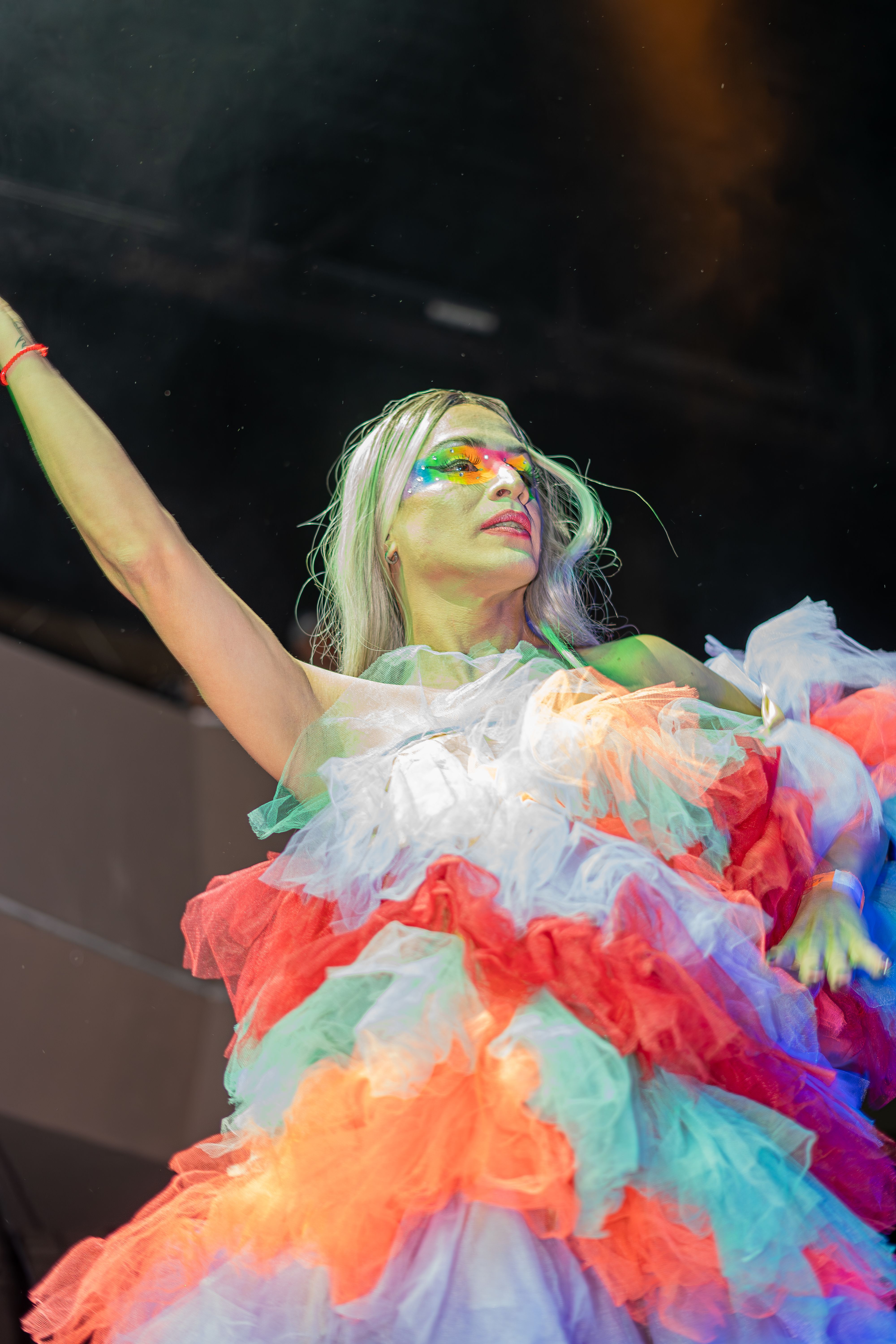 A woman in a colorful dress on stage · Free Stock Photo
