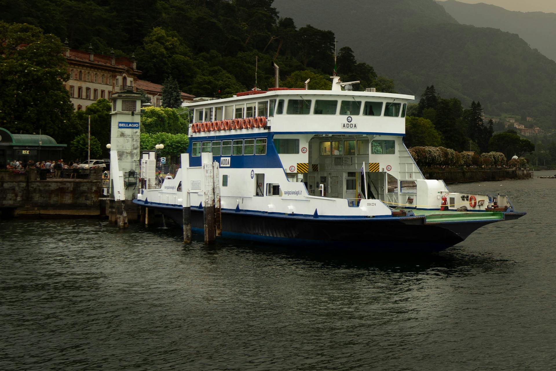 A ferry boat is docked at a dock