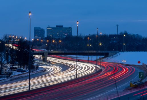Blurred lights of cars on an expressway in Ottawa during the evening. Captured with long exposure.