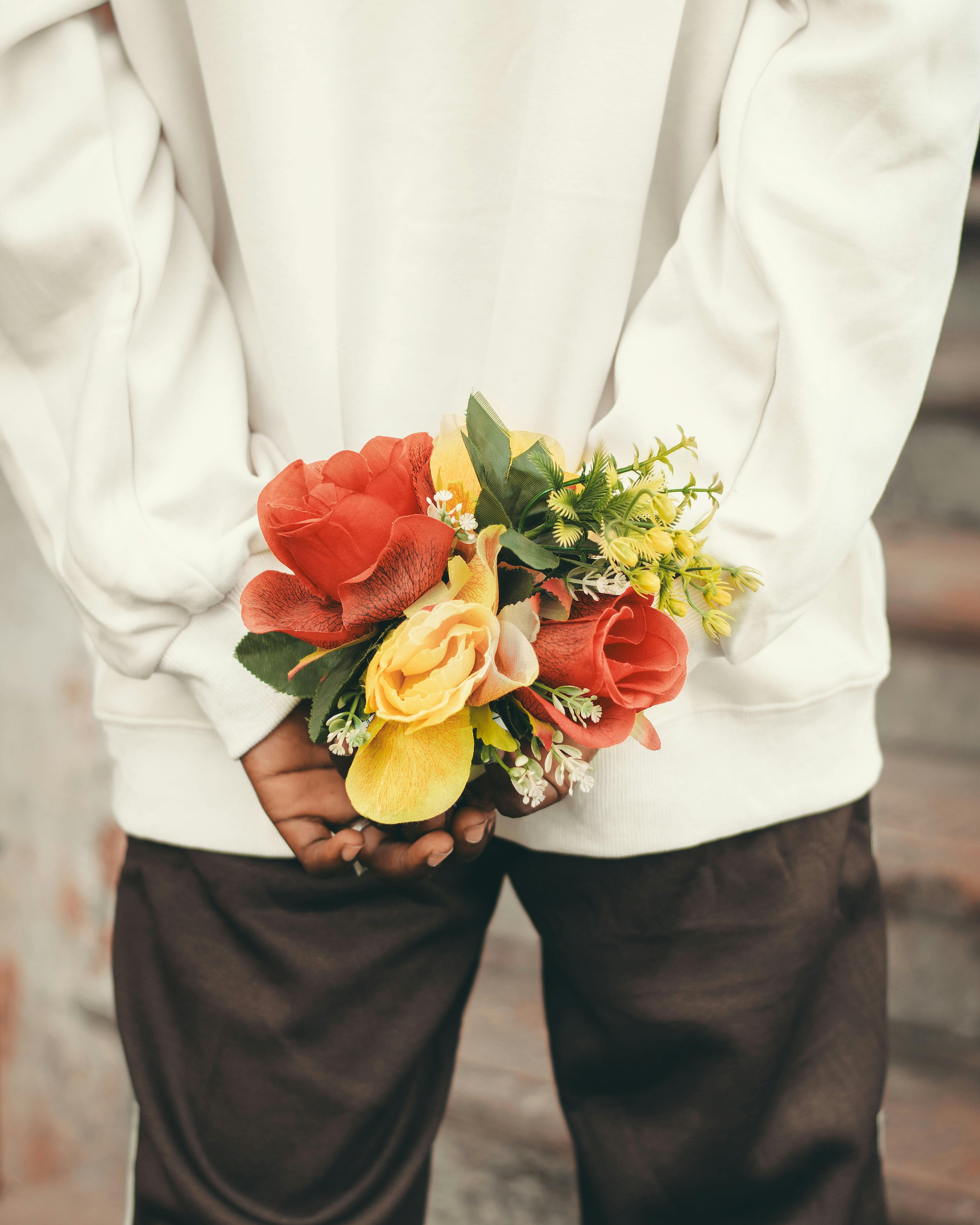 a man holding a bouquet of flowers