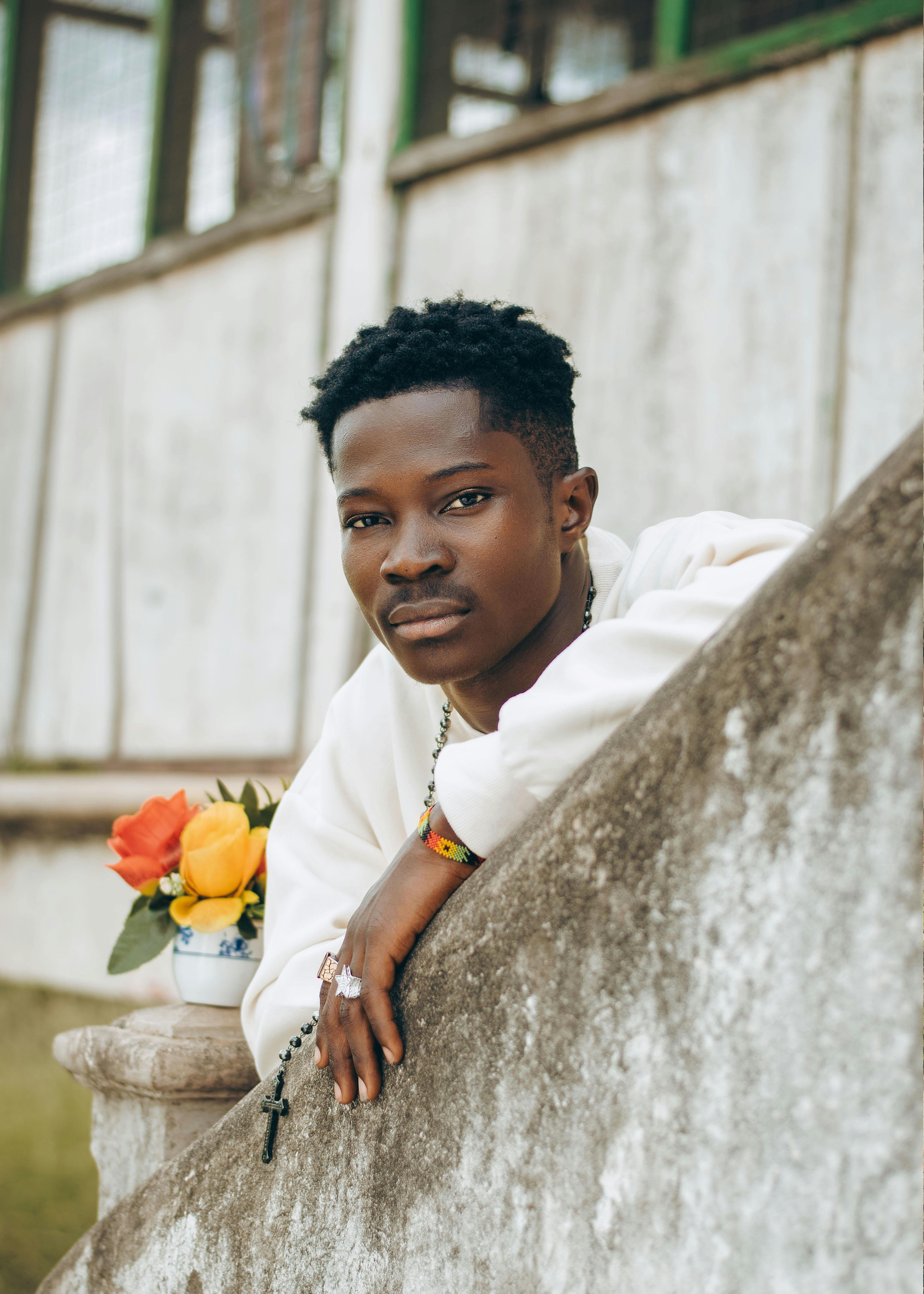 A Young Man Leaning Against A Wall With Flowers Free Stock Photo a-young-man-leaning-against-a-wall-with-flowers-free-stock-photo