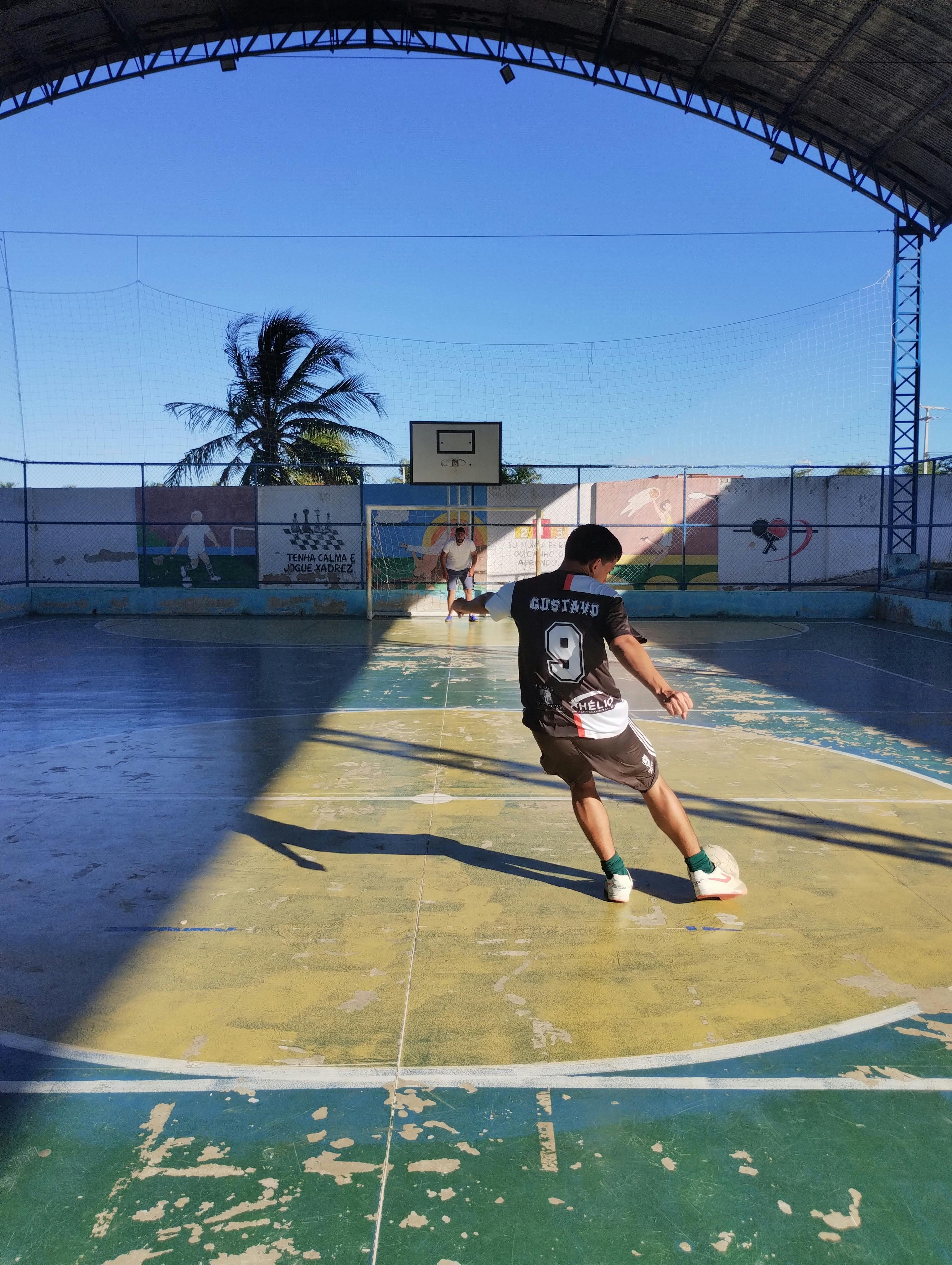 a man playing soccer on an indoor court