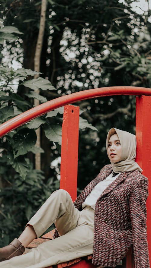 Woman Leaning On Red Railing