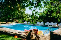 Tranquil pool area surrounded by lush greenery, perfect for relaxation and leisure in a tropical setting.