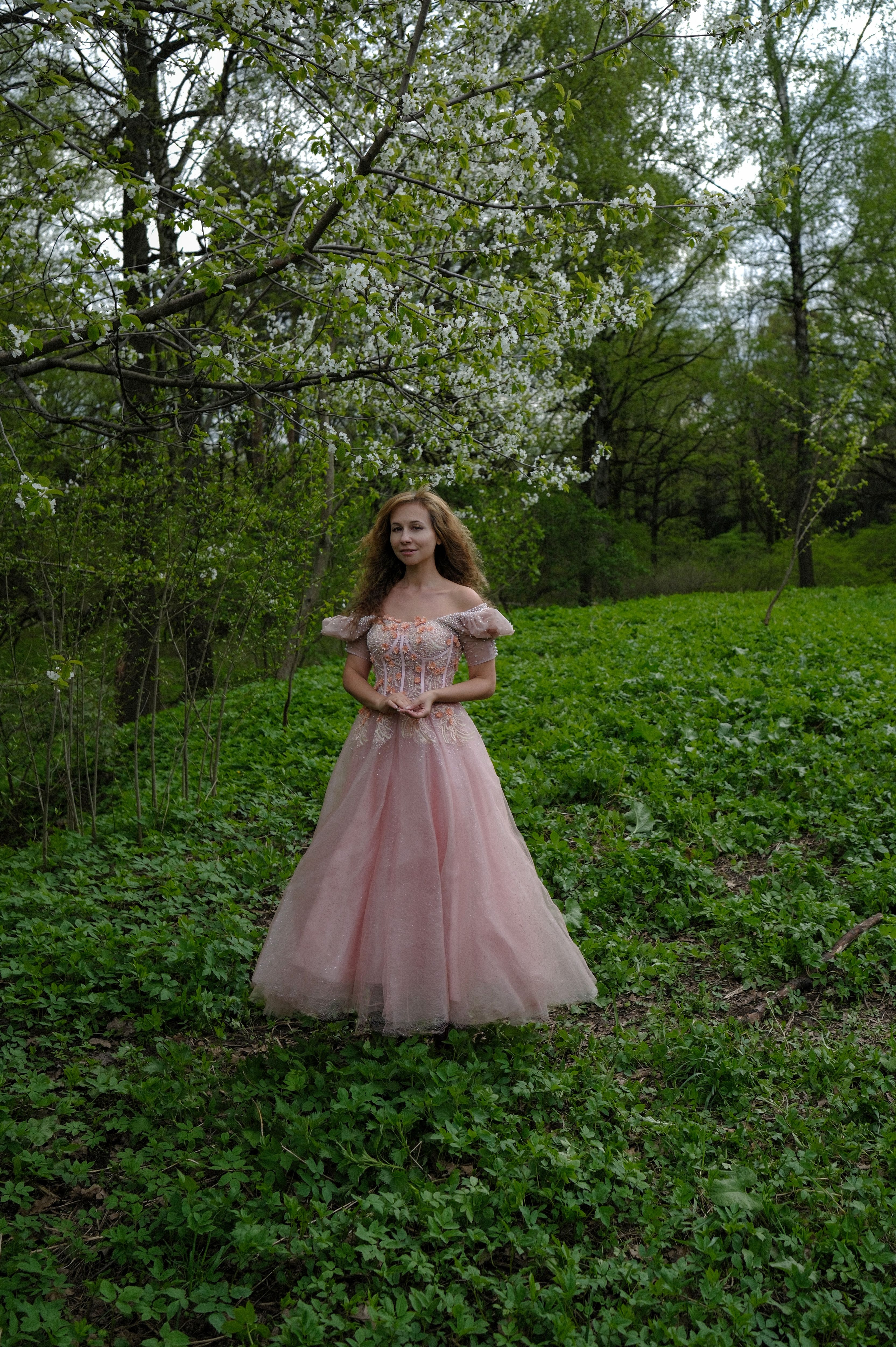 A girl in a pink dress standing in a field · Free Stock Photo