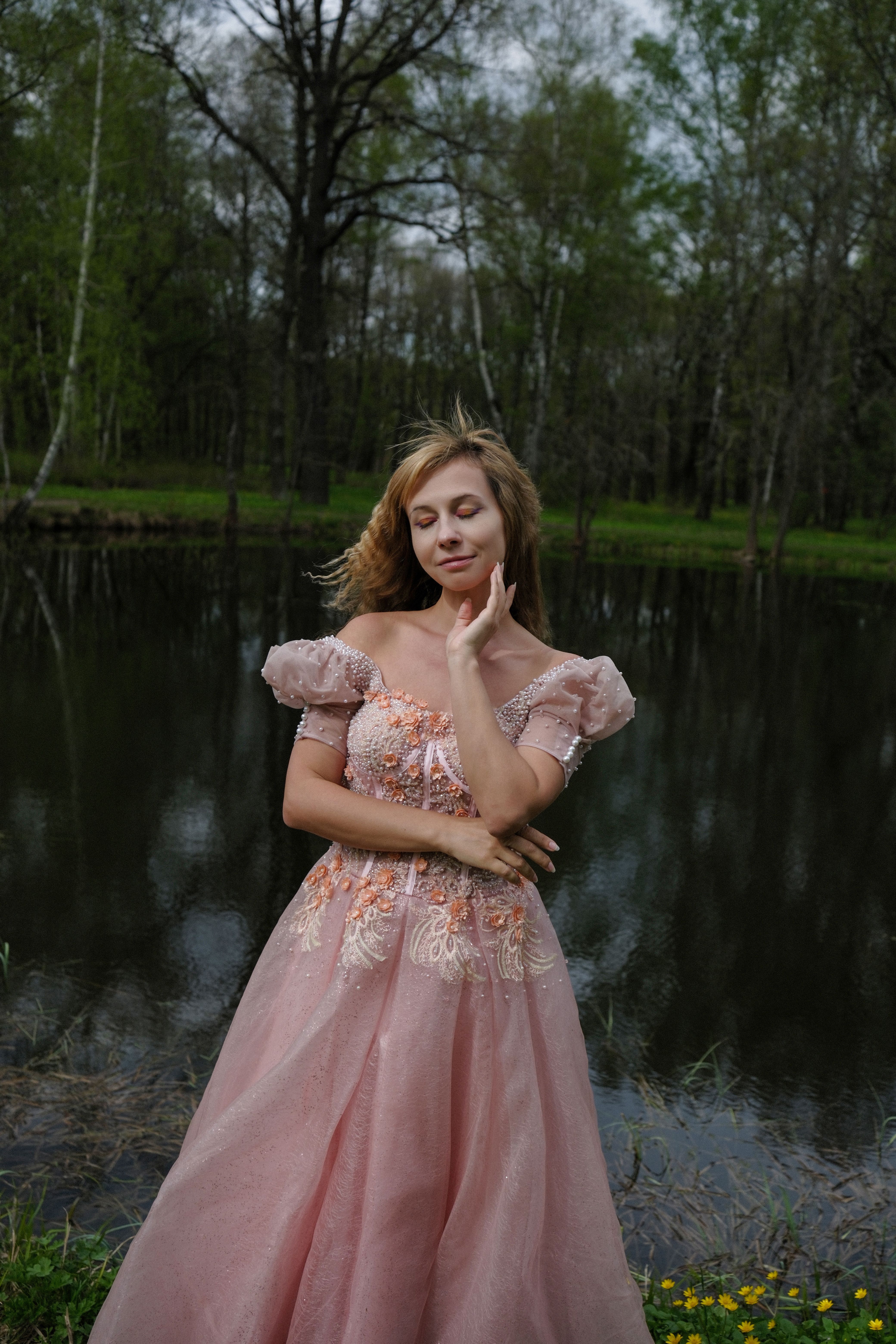 A woman in a pink dress posing by the water · Free Stock Photo