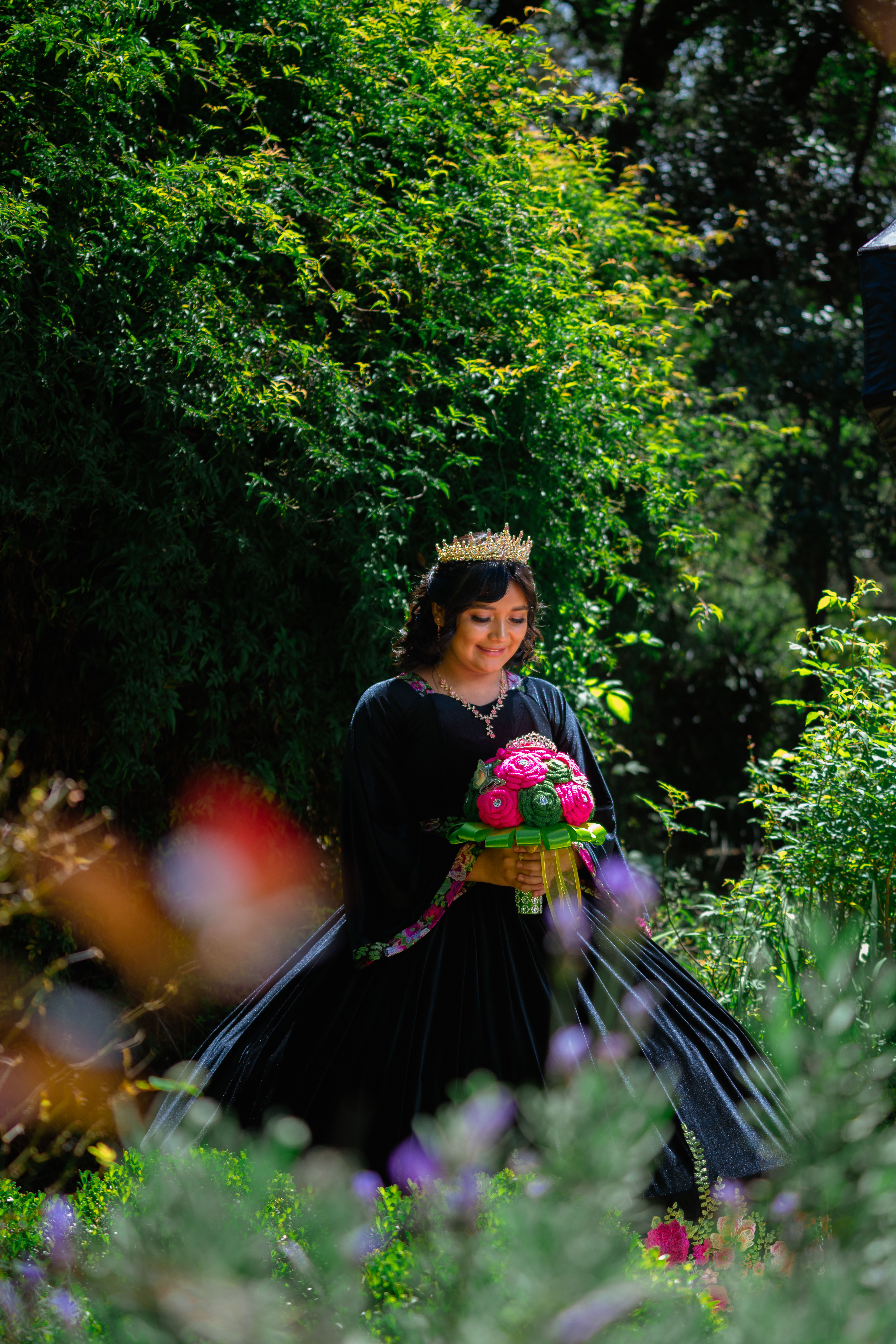 A woman in a black dress holding a bouquet · Free Stock Photo