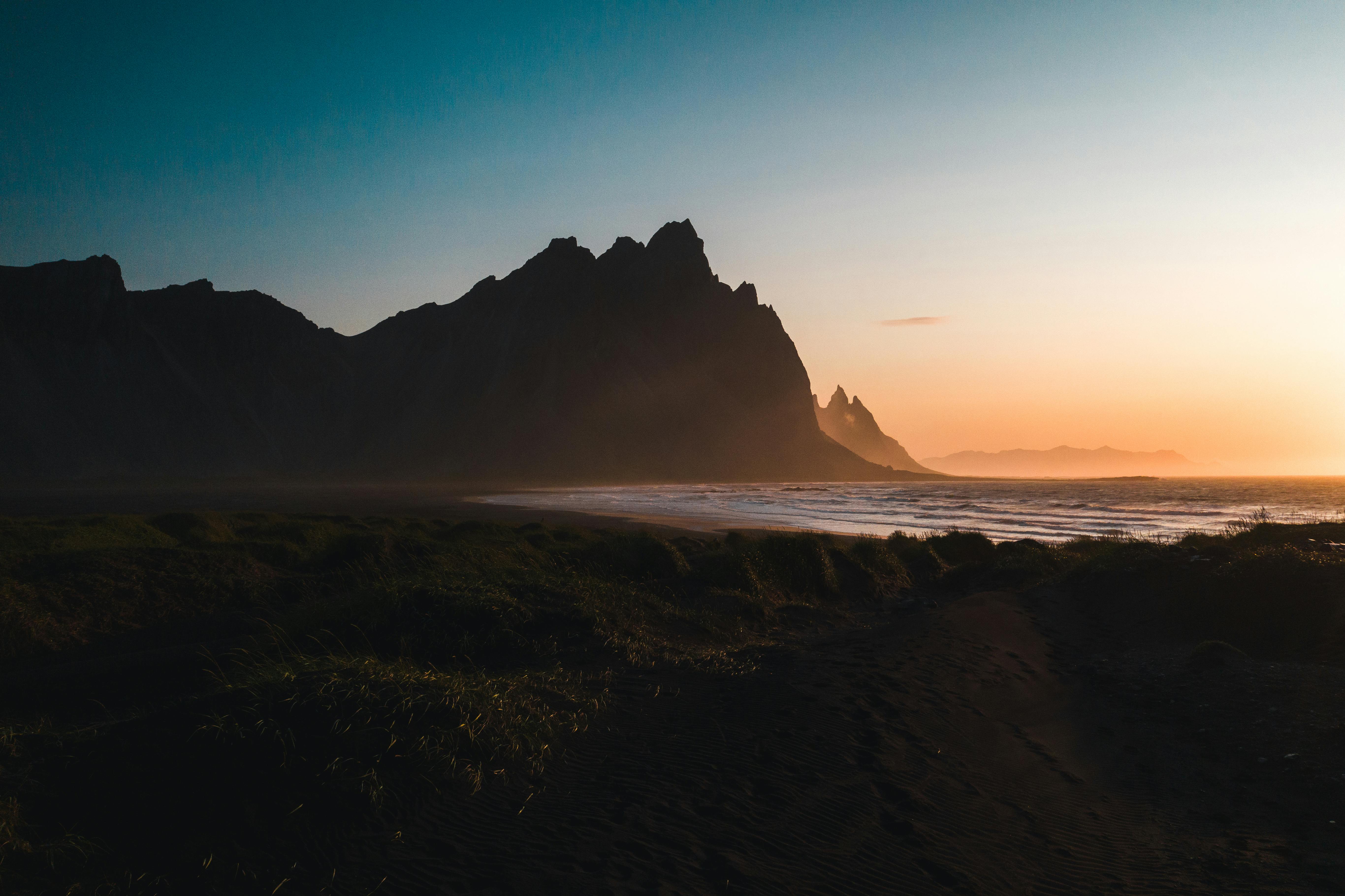 silhouette of a mountain near the beach