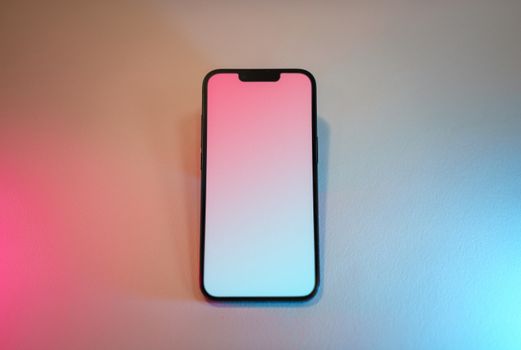 Smartphone with blank gradient screen and colorful lighting for mockup use.