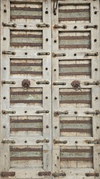 A vintage wooden door with metal details showcasing a rustic, aged texture.