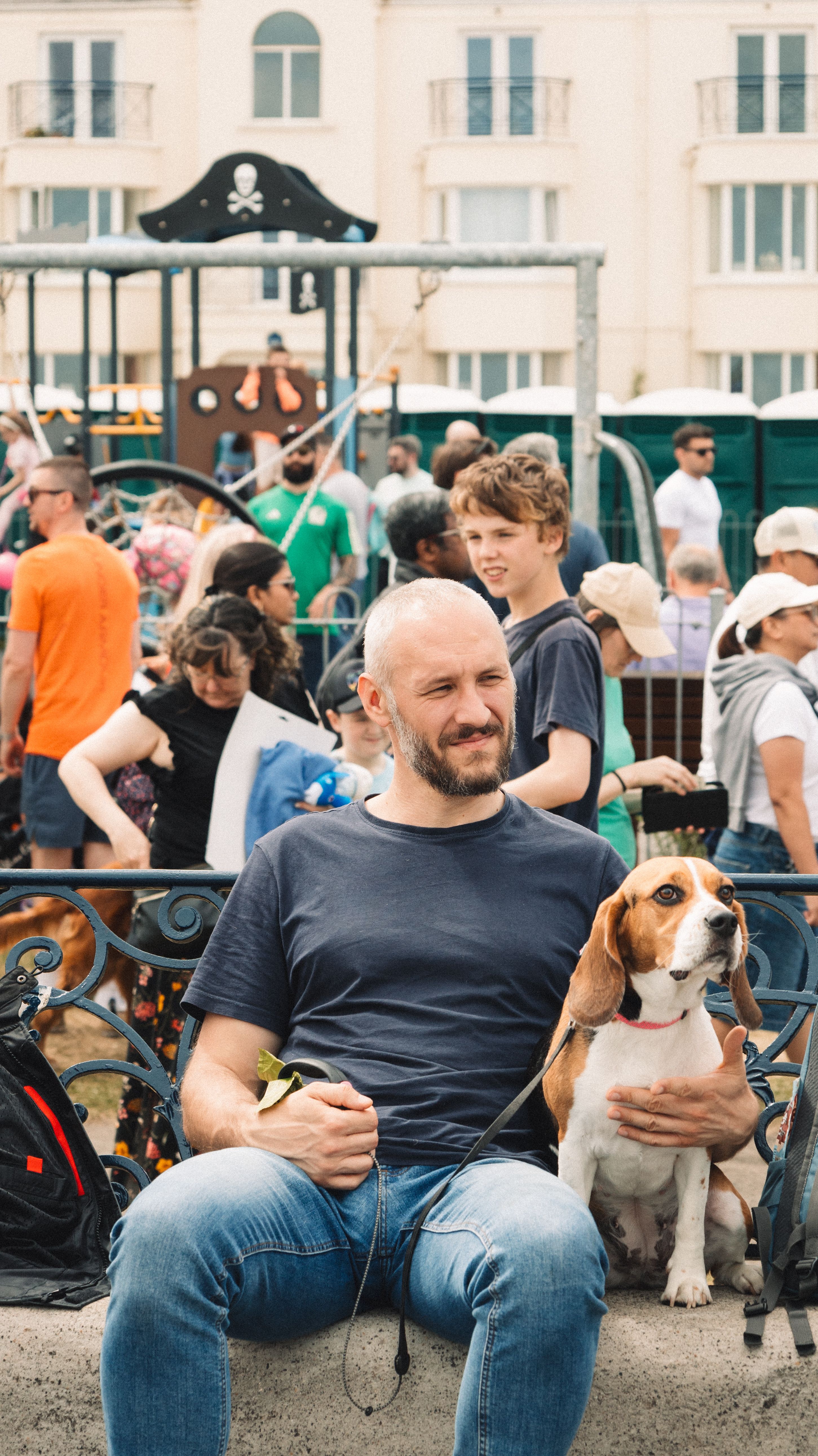 A man sitting on a bench with a dog · Free Stock Photo
