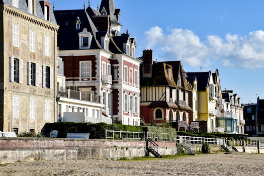 Explore picturesque beachfront architecture in Deauville, France, with vibrant homes by the sea.
