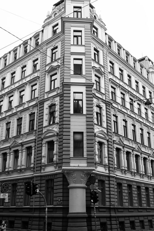 Free Black and white photo of a historic architectural building in Riga, showcasing detailed facade and urban design. Stock Photo