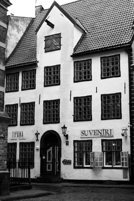 Charming black and white photo of a historic building in old Riga, showcasing classic architecture.