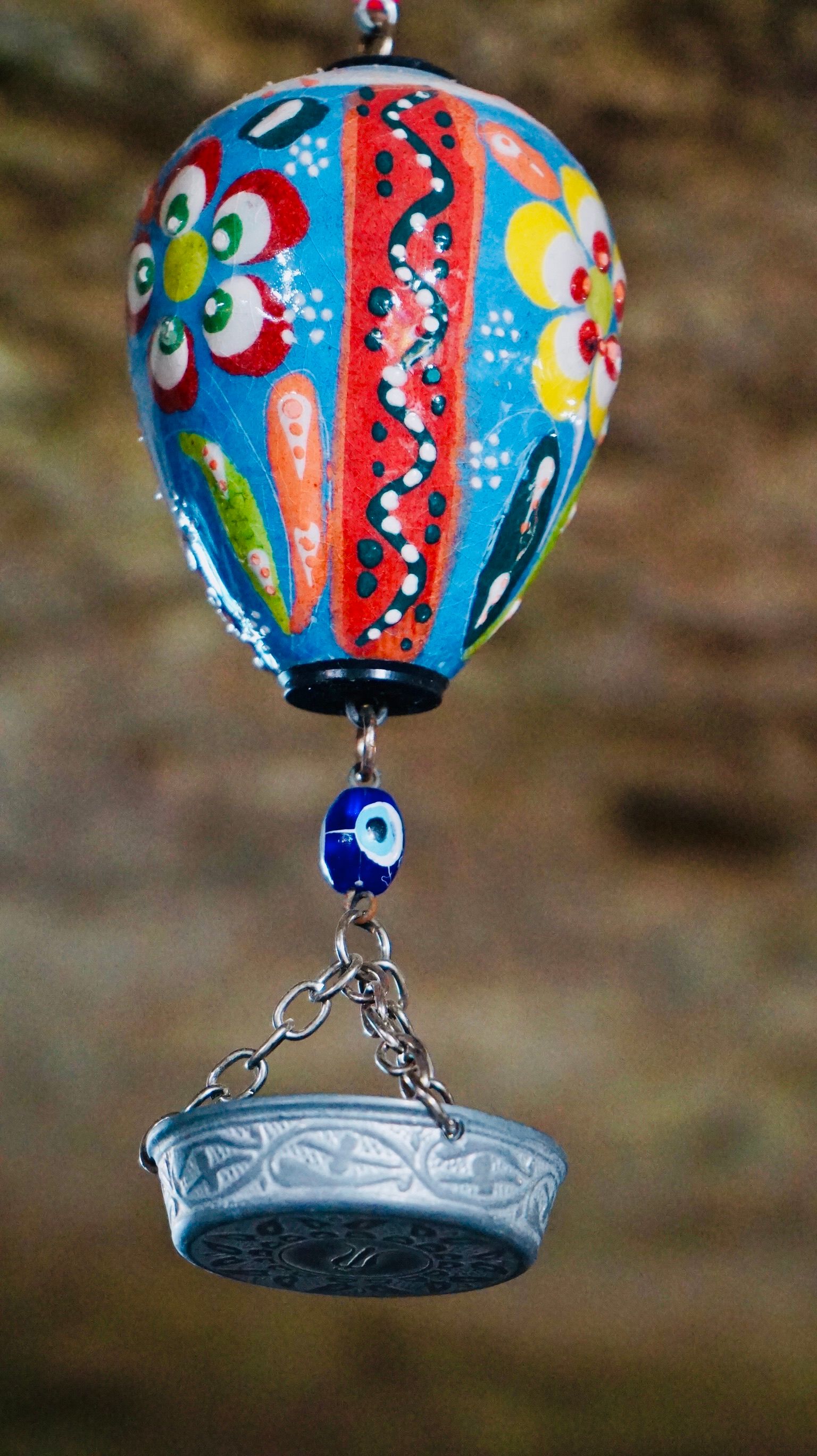 Colorful handmade Turkish ornament featuring evil eye and floral patterns.