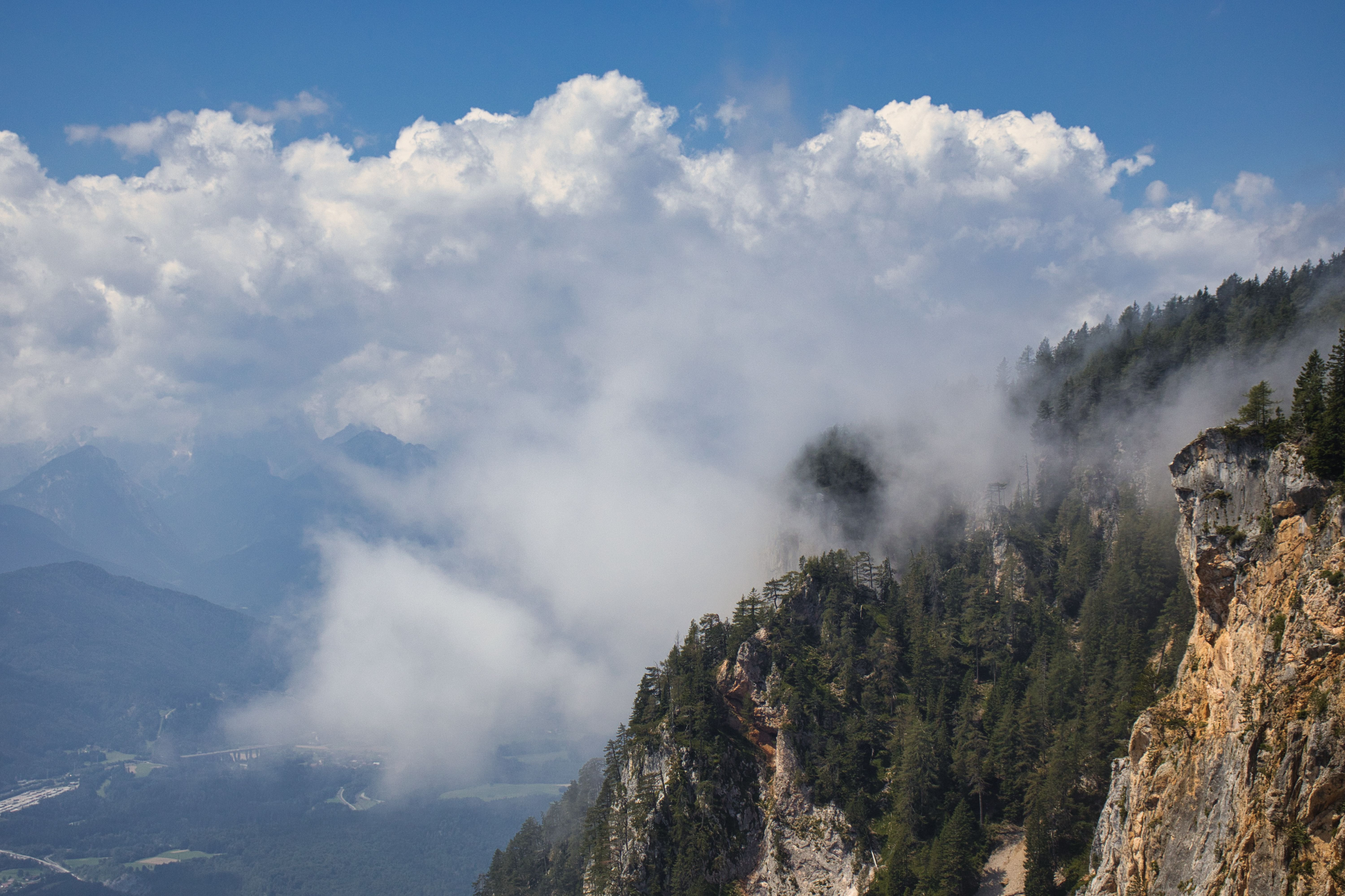 A mountain with clouds and fog on it · Free Stock Photo