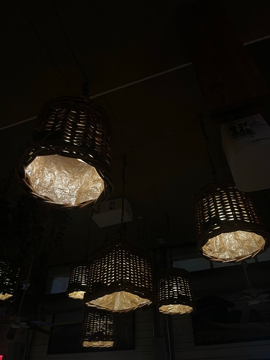 Decorative wicker lamps casting a warm glow in a dim setting, creating a cozy atmosphere.