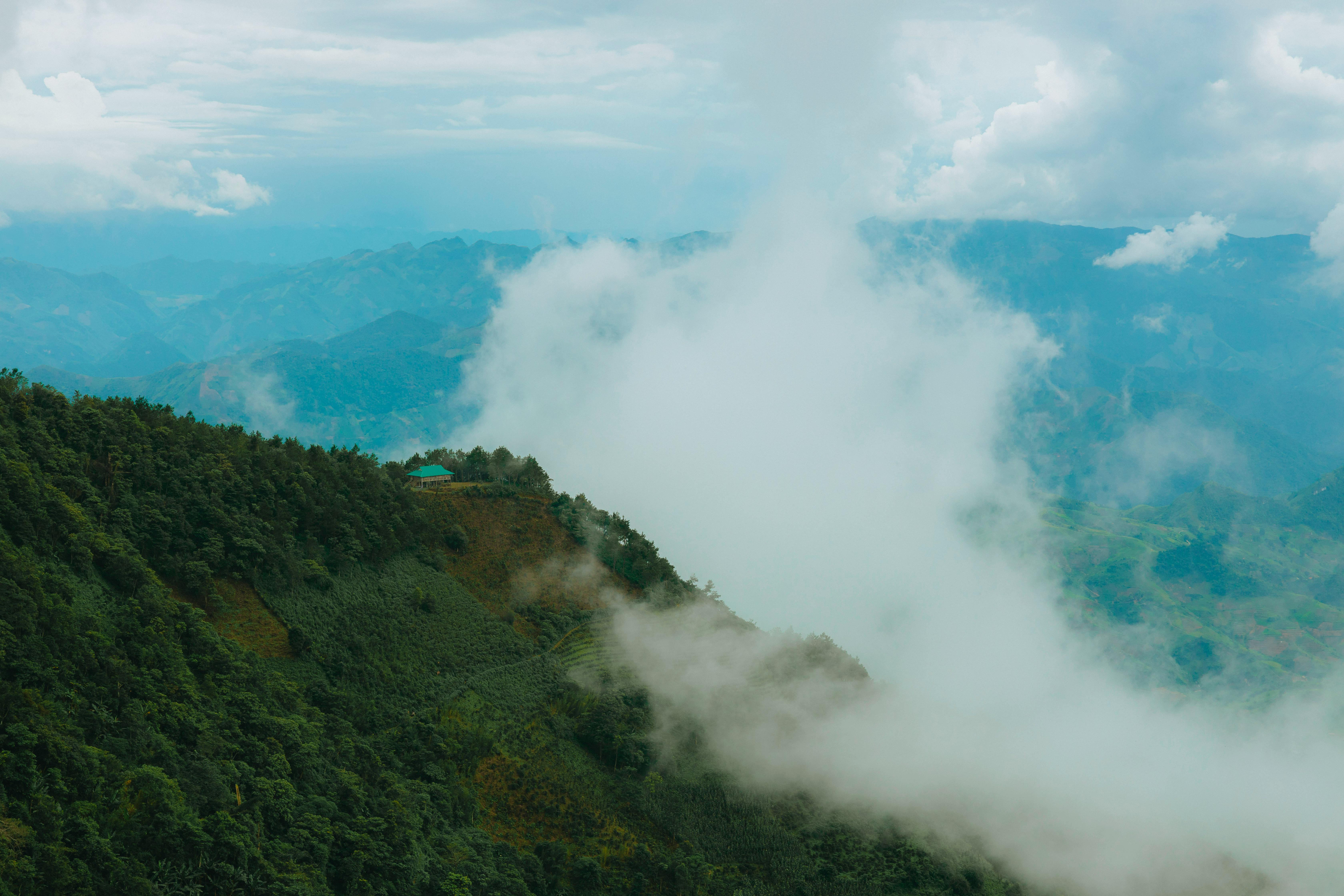 a view of a mountain range with clouds in the sky