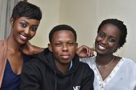 Happy group portrait of young adults posing together indoors in Kigali, Rwanda.