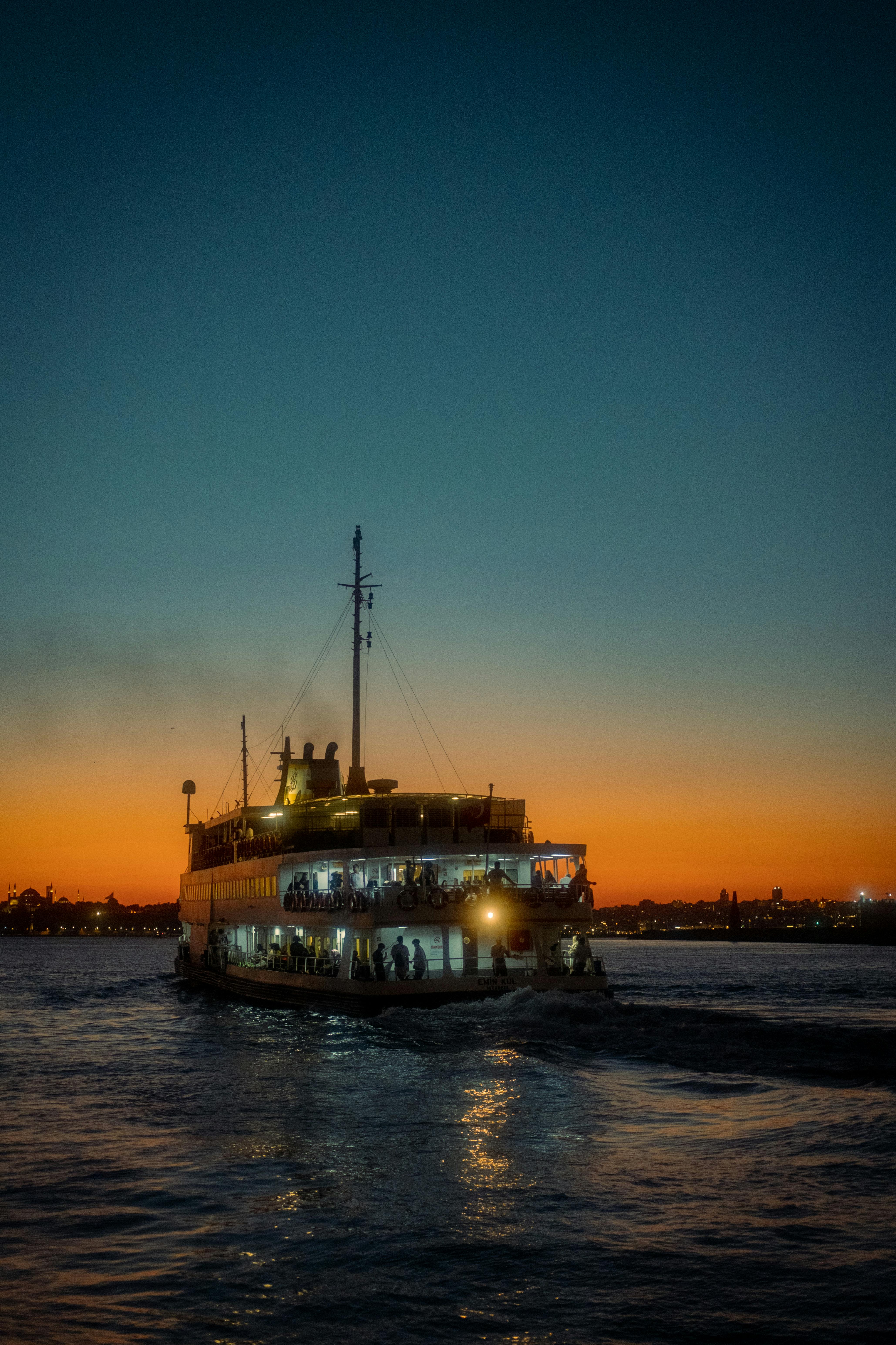 a ferry boat is traveling on the water at sunset