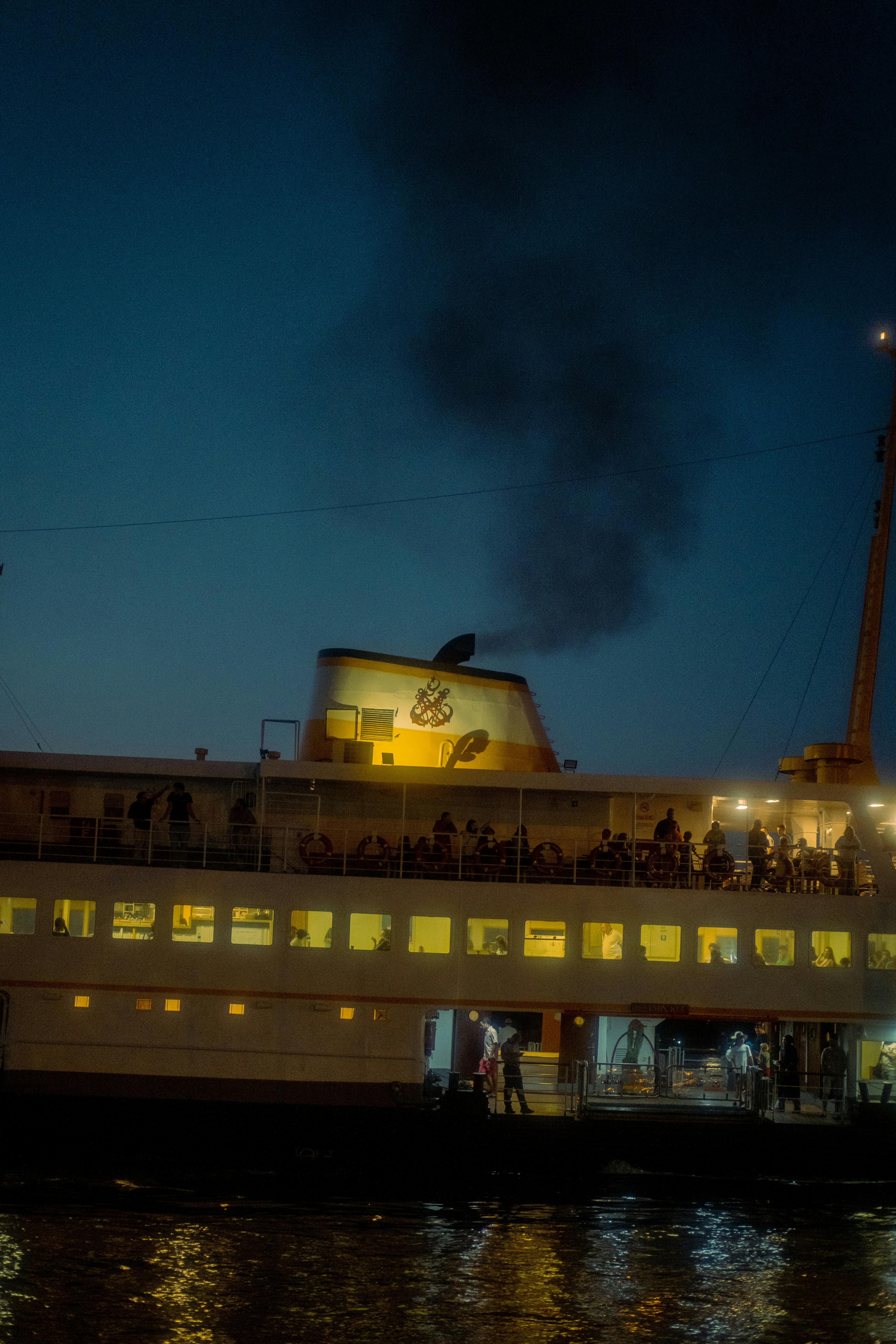 a ferry boat with smoke coming out of it