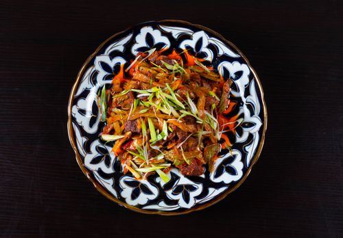 Free A vibrant stir-fry with vegetables and meat on an ornate plate, perfect for an Asian-inspired meal. Stock Photo