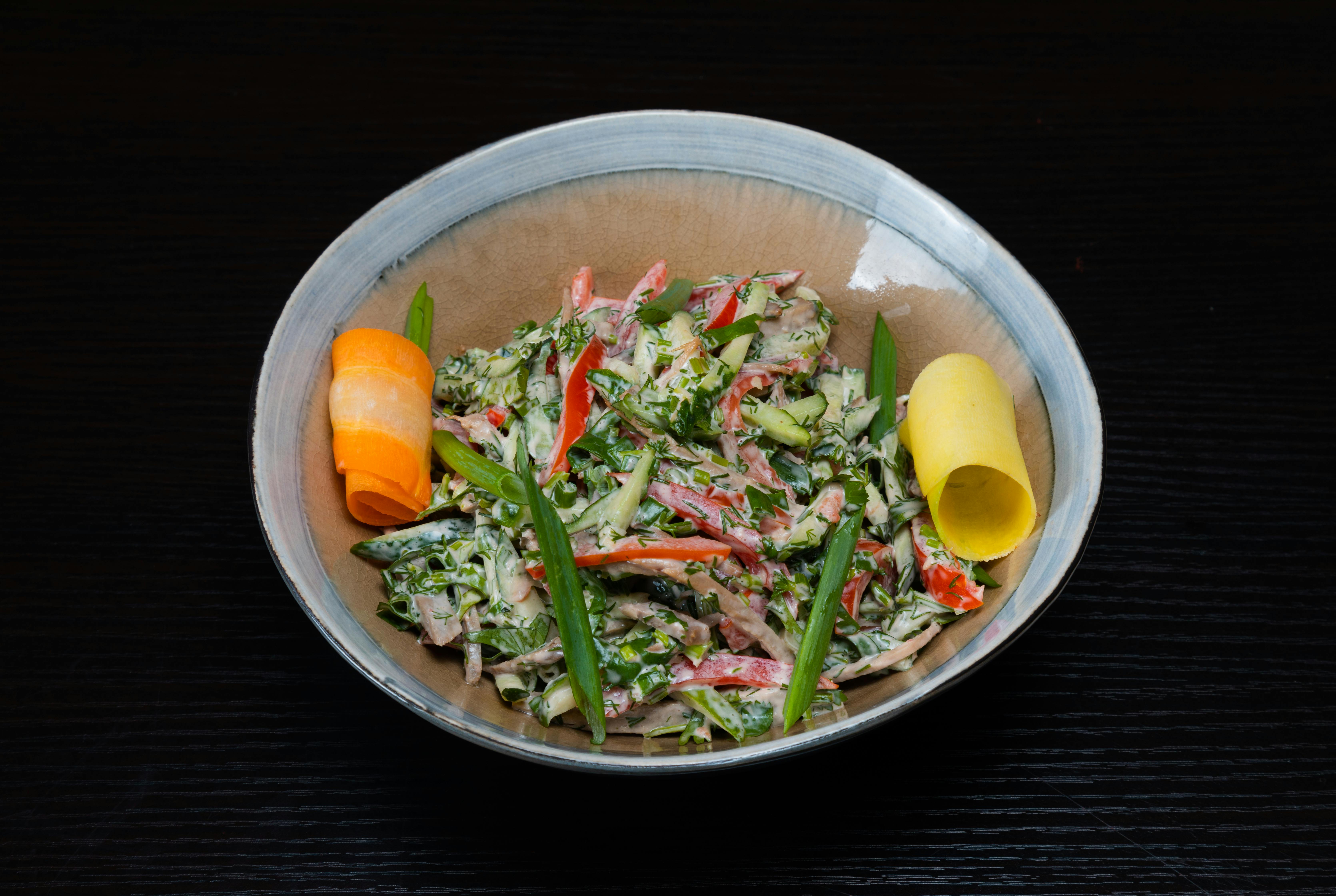 a bowl of food with vegetables and carrots