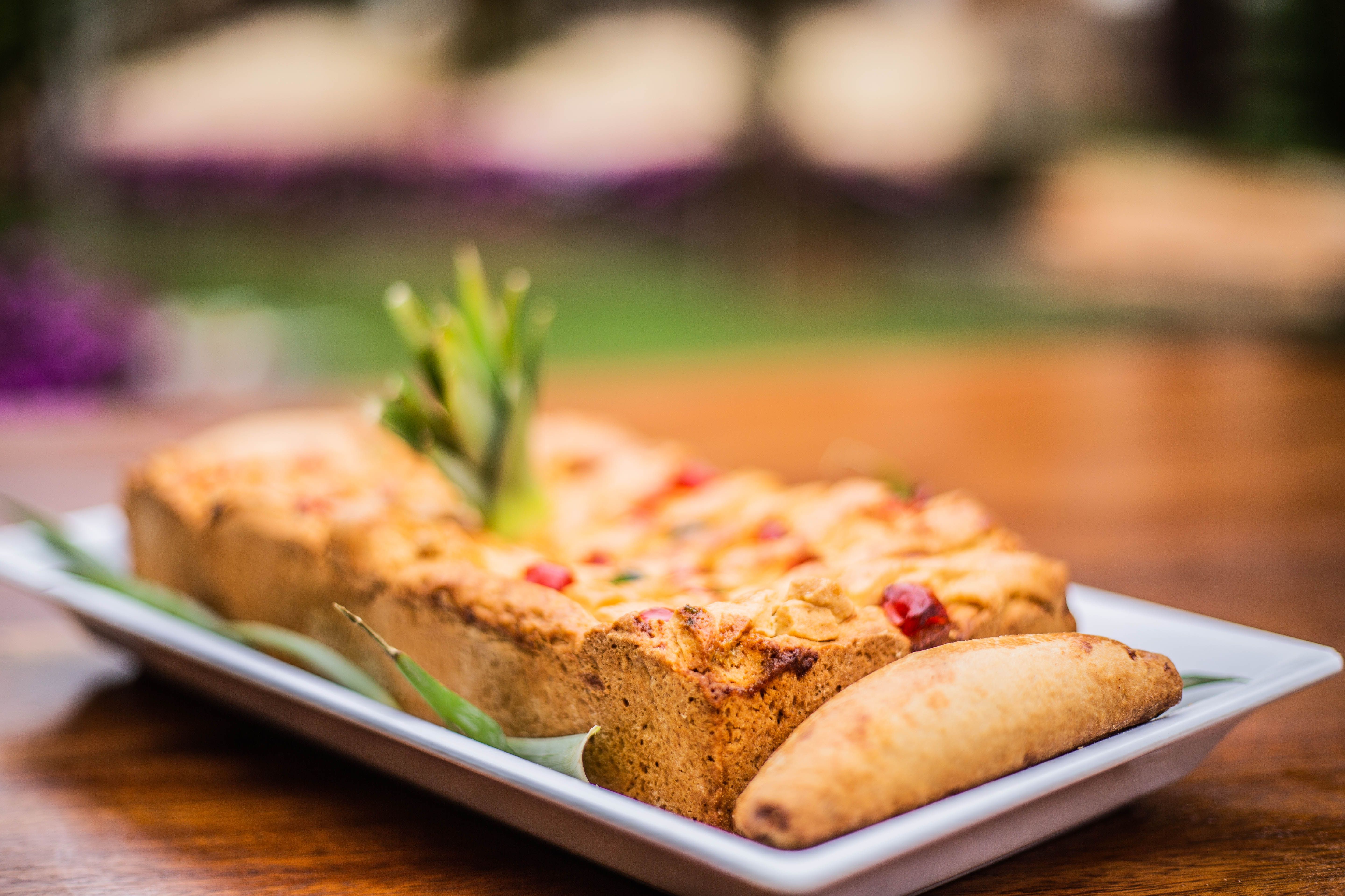 Close-up of homemade fruit bread with a pastry, presented elegantly outdoors.