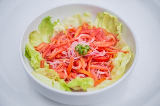Bright and colorful vegetable salad with lettuce and tomato, perfect for a healthy meal.