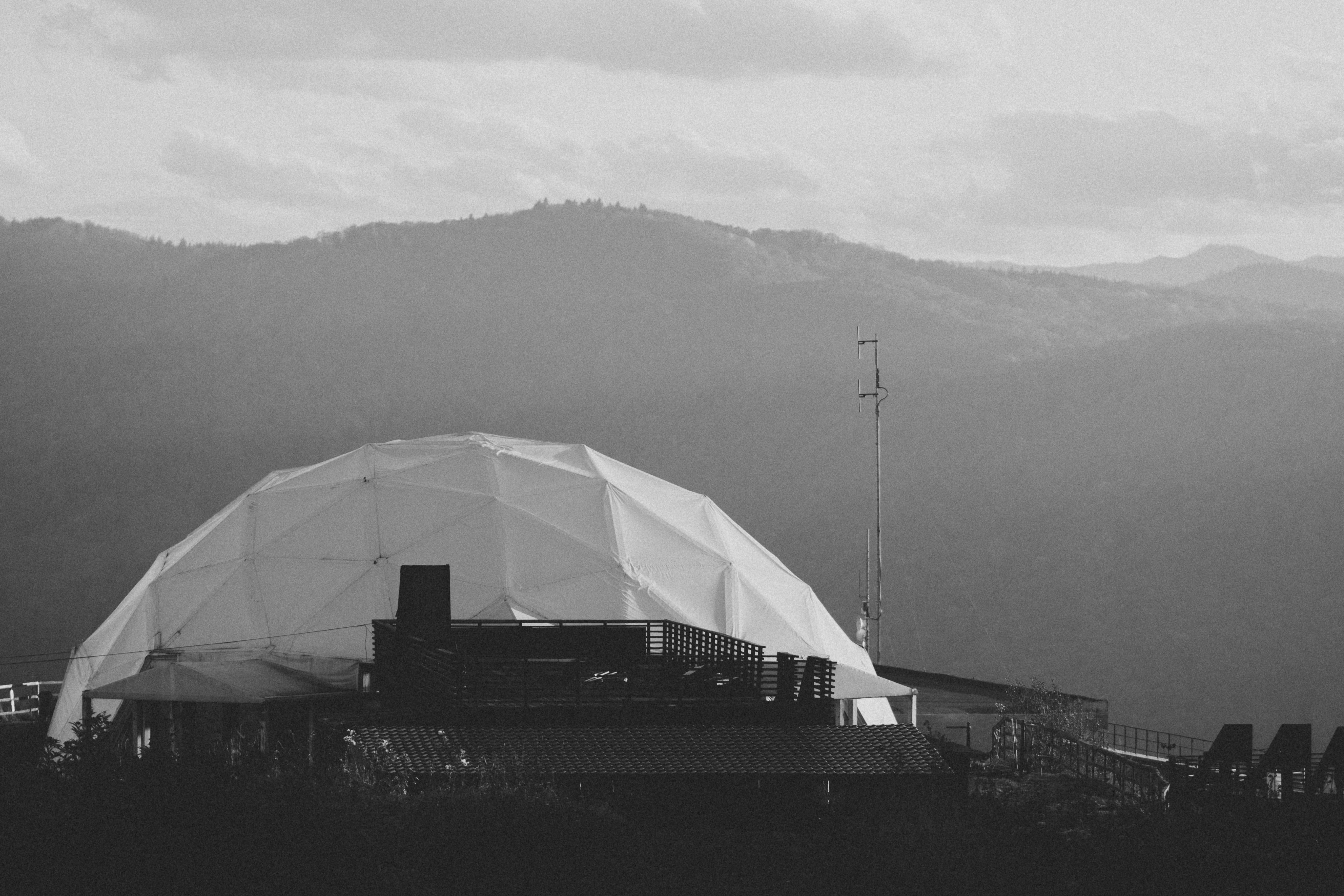 Exterior view of a geodesic dome accommodation in a natural setting