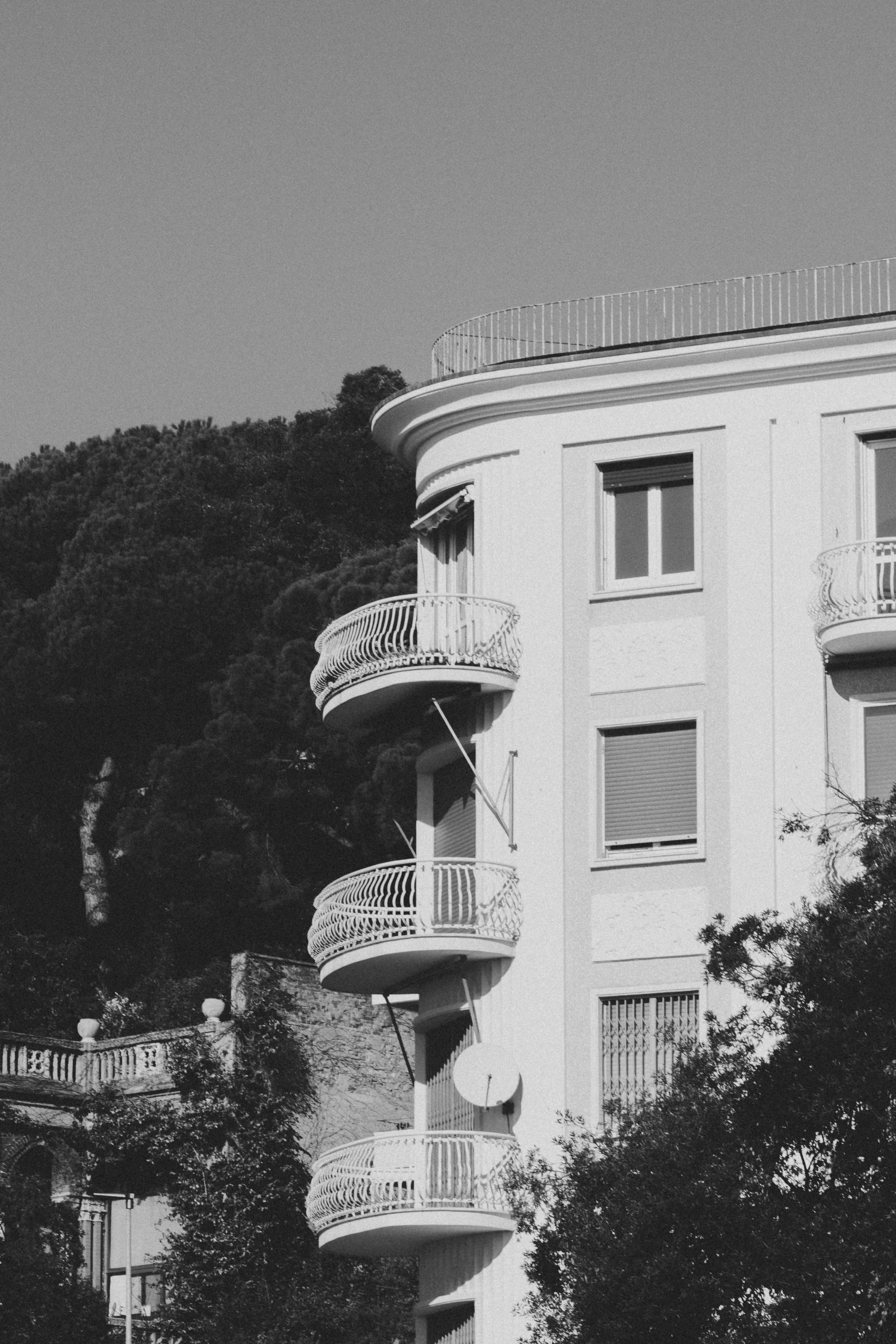 Black and white photo of a building with balconies · Free Stock Photo