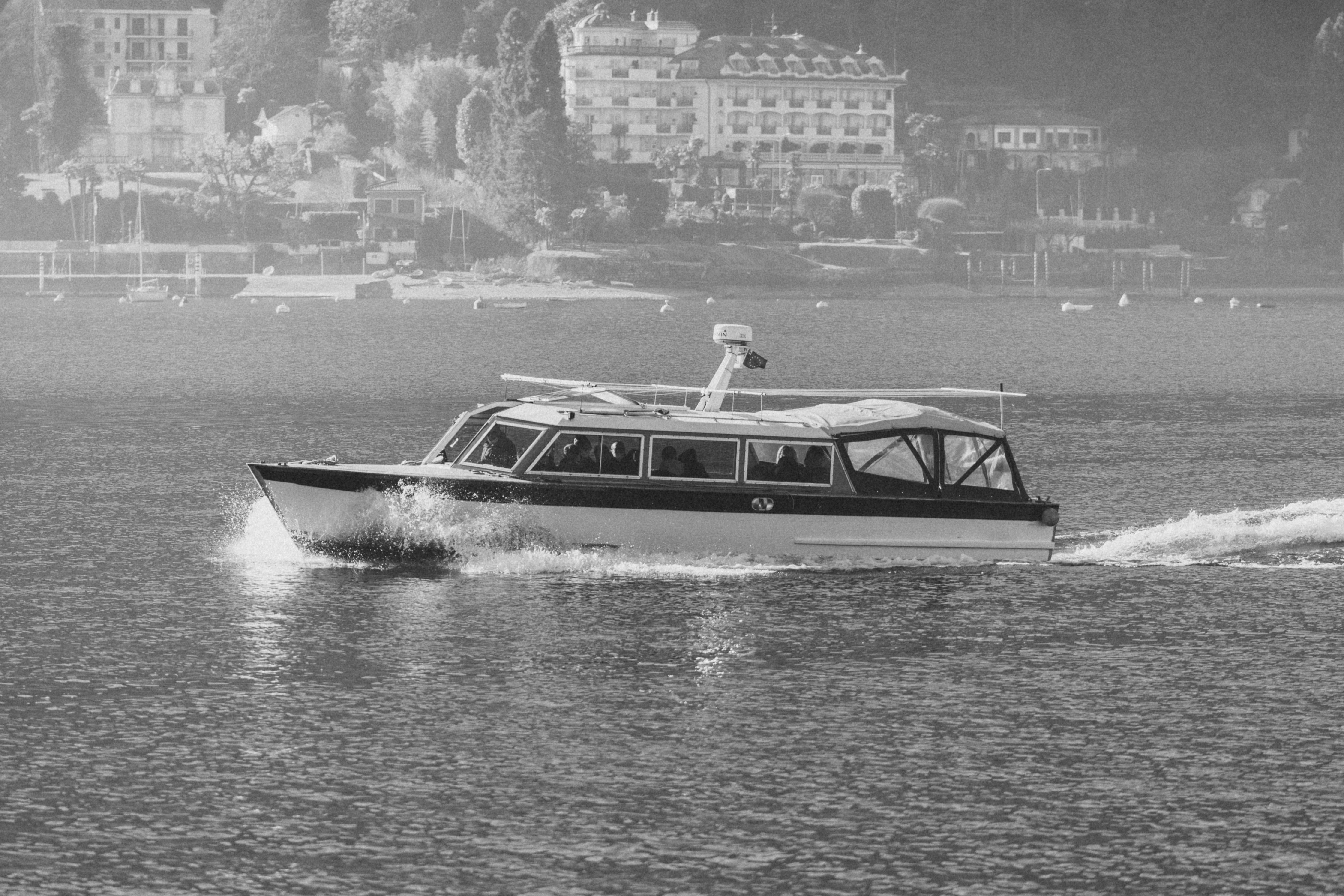 Motorboat on a serene lake with a scenic backdrop.