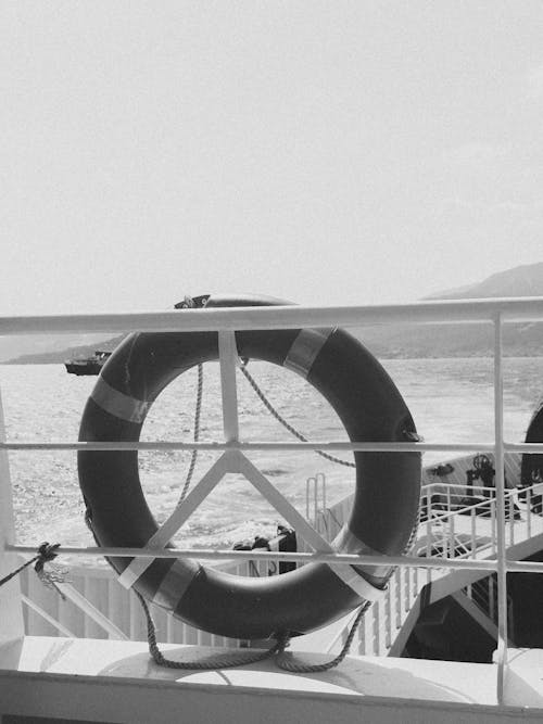 Free Monochrome view from a ship's deck featuring a lifebuoy and sea landscape. Stock Photo