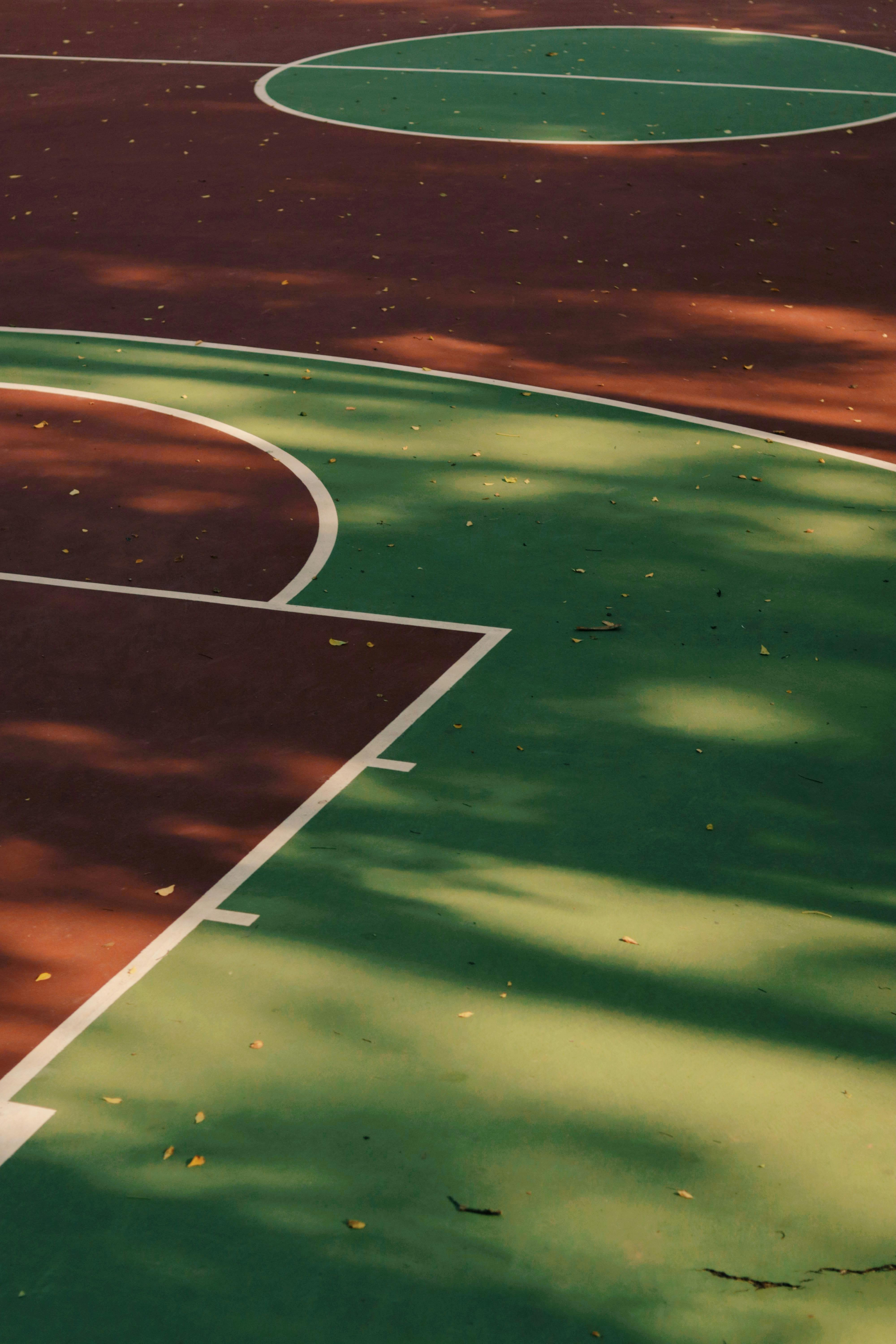 a basketball court with a green and red court