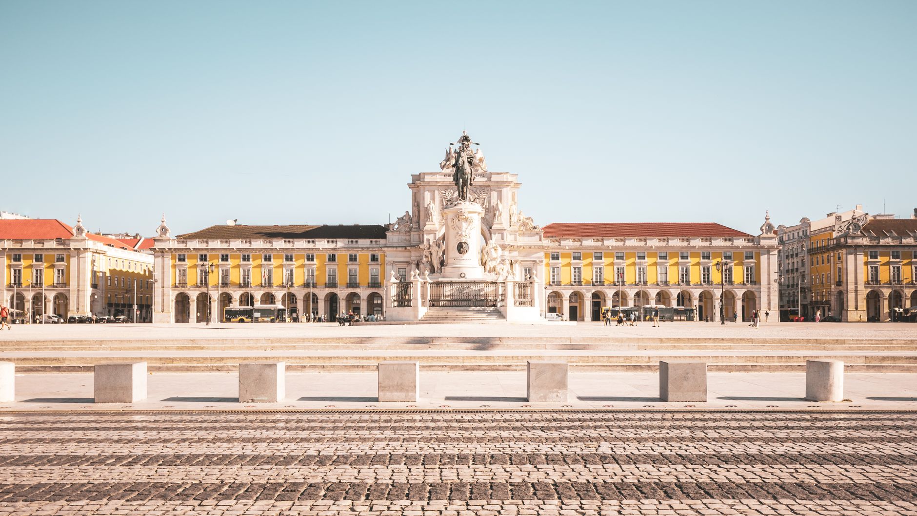 Wide view of Praça do Comércio with iconic architecture in Lisbon, Portugal.