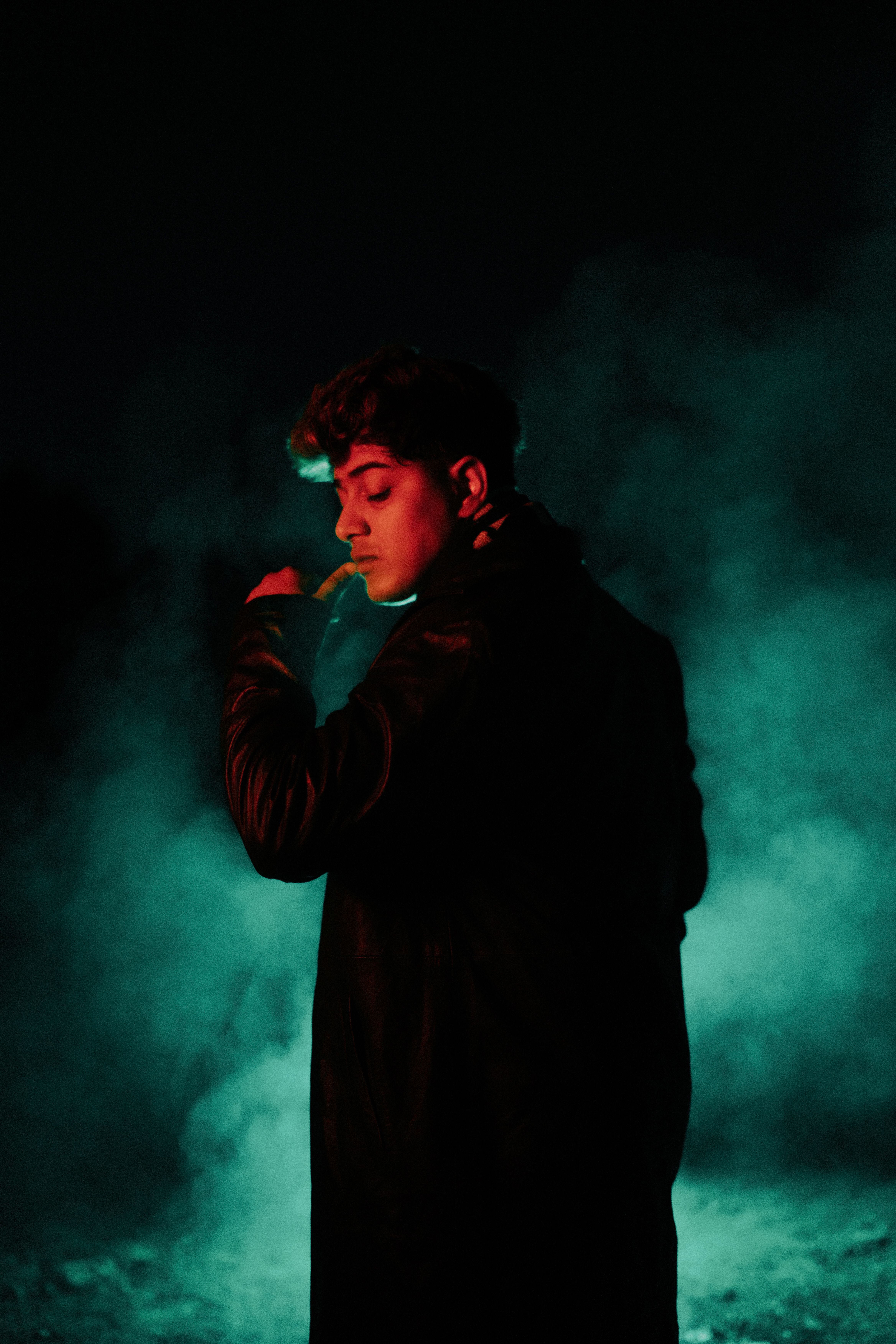 A man smoking in the dark with smoke coming out of his mouth · Free ...